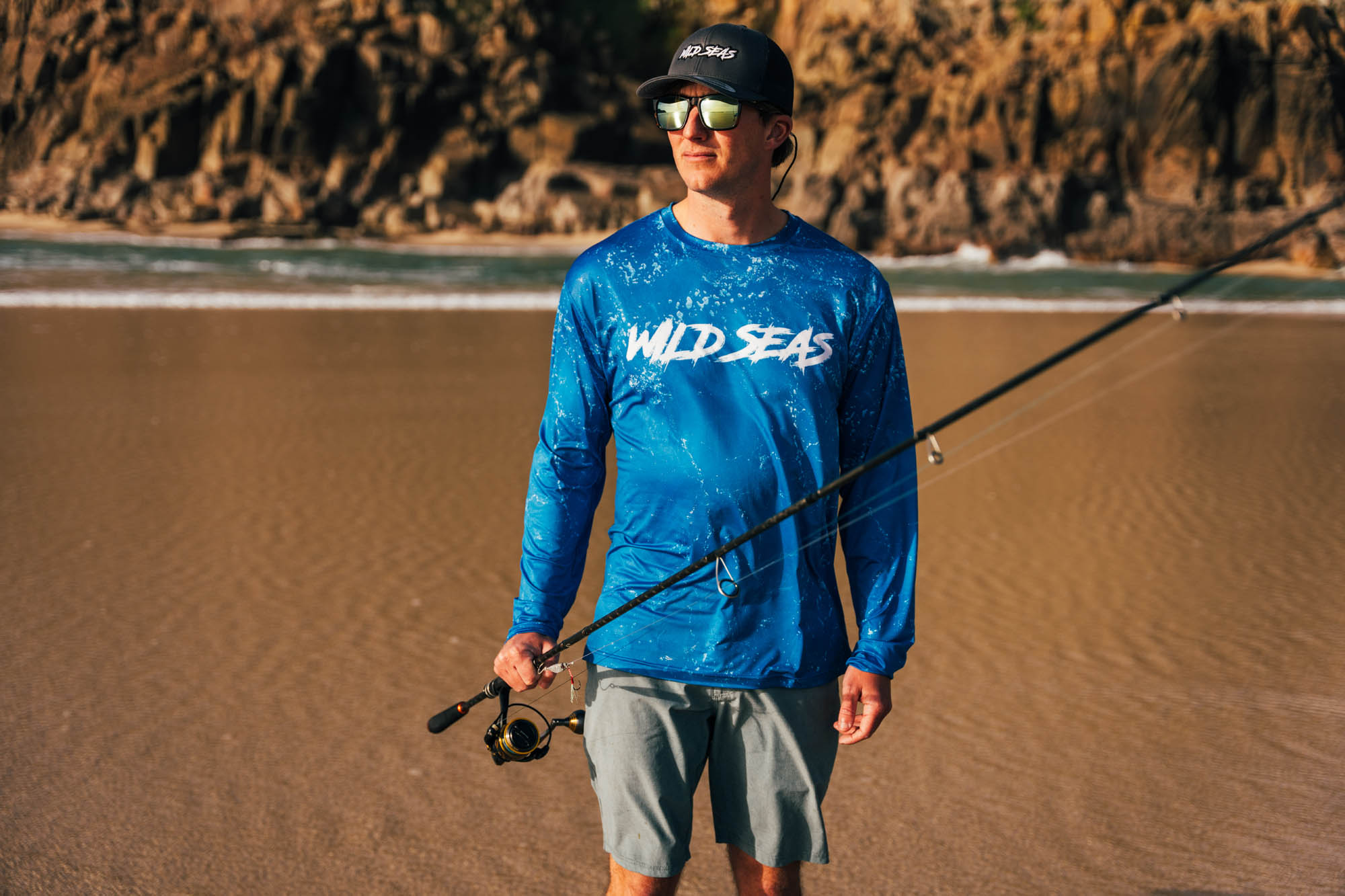 Wild Seas Performance Long Sleeve UV Shirt worn by an angler on a beach